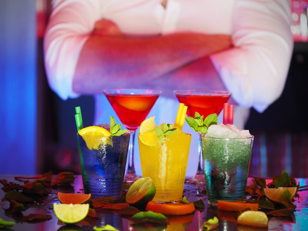 man standing before prepared cocktails